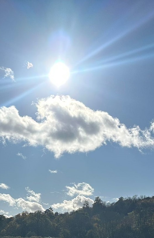 Sun in blue ski above clouds